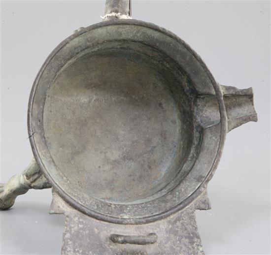 A Chinese archaic bronze tripod ritual wine-warming vessel, Jiao Dou, Southern & Northern dynasties, 6th century A.D., 31cm long, 22cm